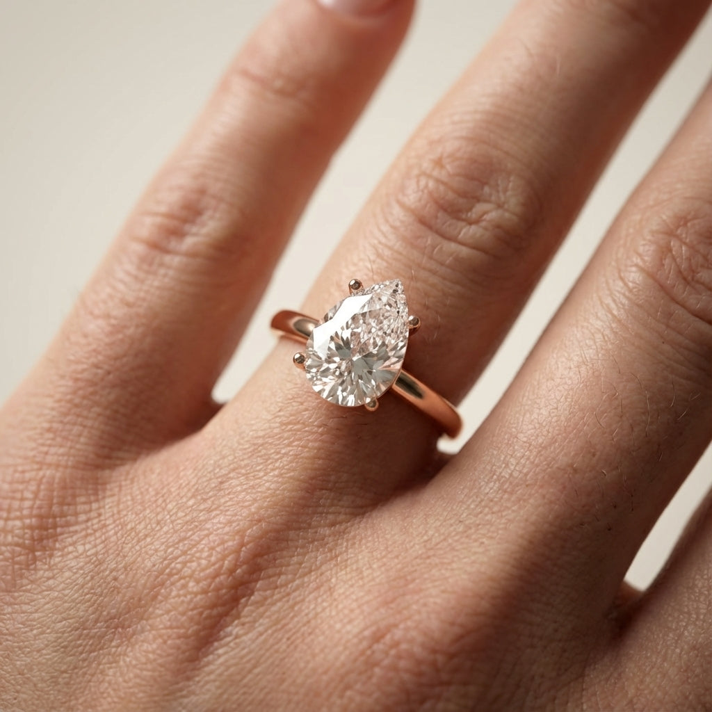 Pear Cut Lab Grown Diamond Solitaire Engagement Ring in Rose Gold showing side profile scrollwork