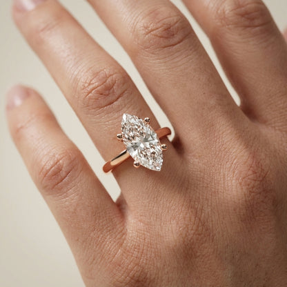 Rose Gold Marquise Cut Lab Grown Diamond Solitaire Engagement Ring with hidden scrollwork underneath.