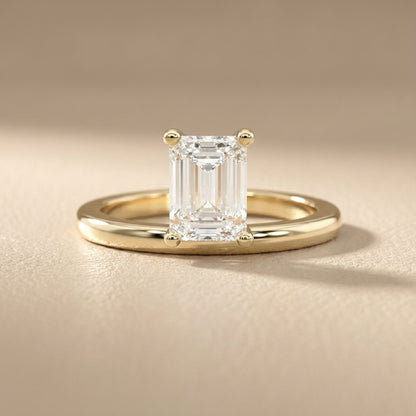 Emerald Cut Lab Grown Diamond Solitaire Engagement Ring in traditional Yellow Gold setting.