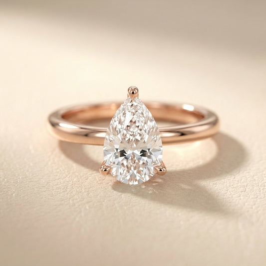 Pear Cut Lab Grown Diamond Solitaire Engagement Ring in Rose Gold with claw prongs and chevron basket.
