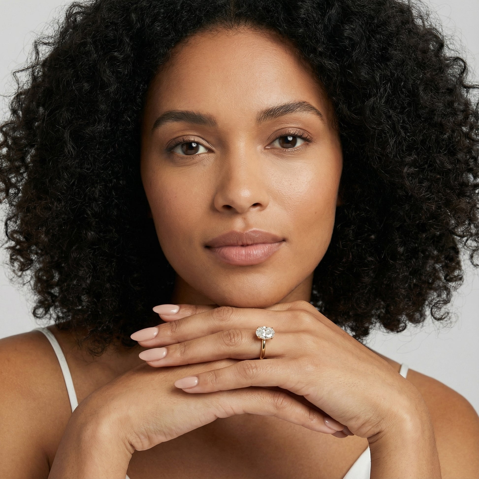 Oval Cut Lab Grown Diamond Engagement Ring in Yellow Gold with chevron under-bezel detail