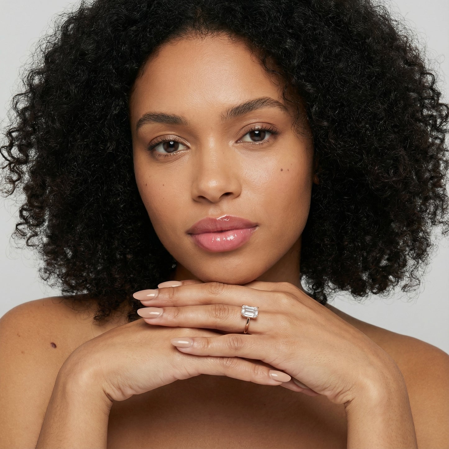 Emerald Cut Lab Grown Diamond Solitaire Engagement Ring in warm Rose Gold setting.