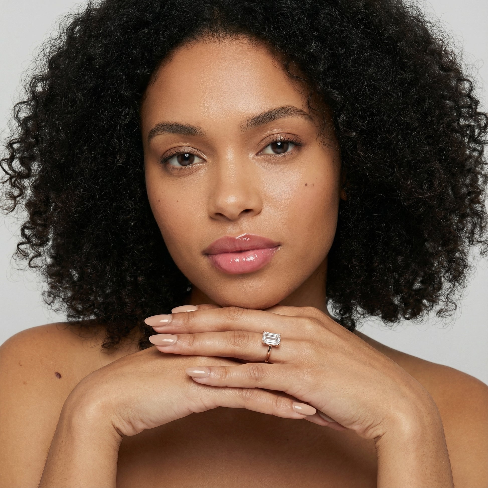 Emerald Cut Lab Grown Diamond Solitaire Engagement Ring in warm Rose Gold setting.