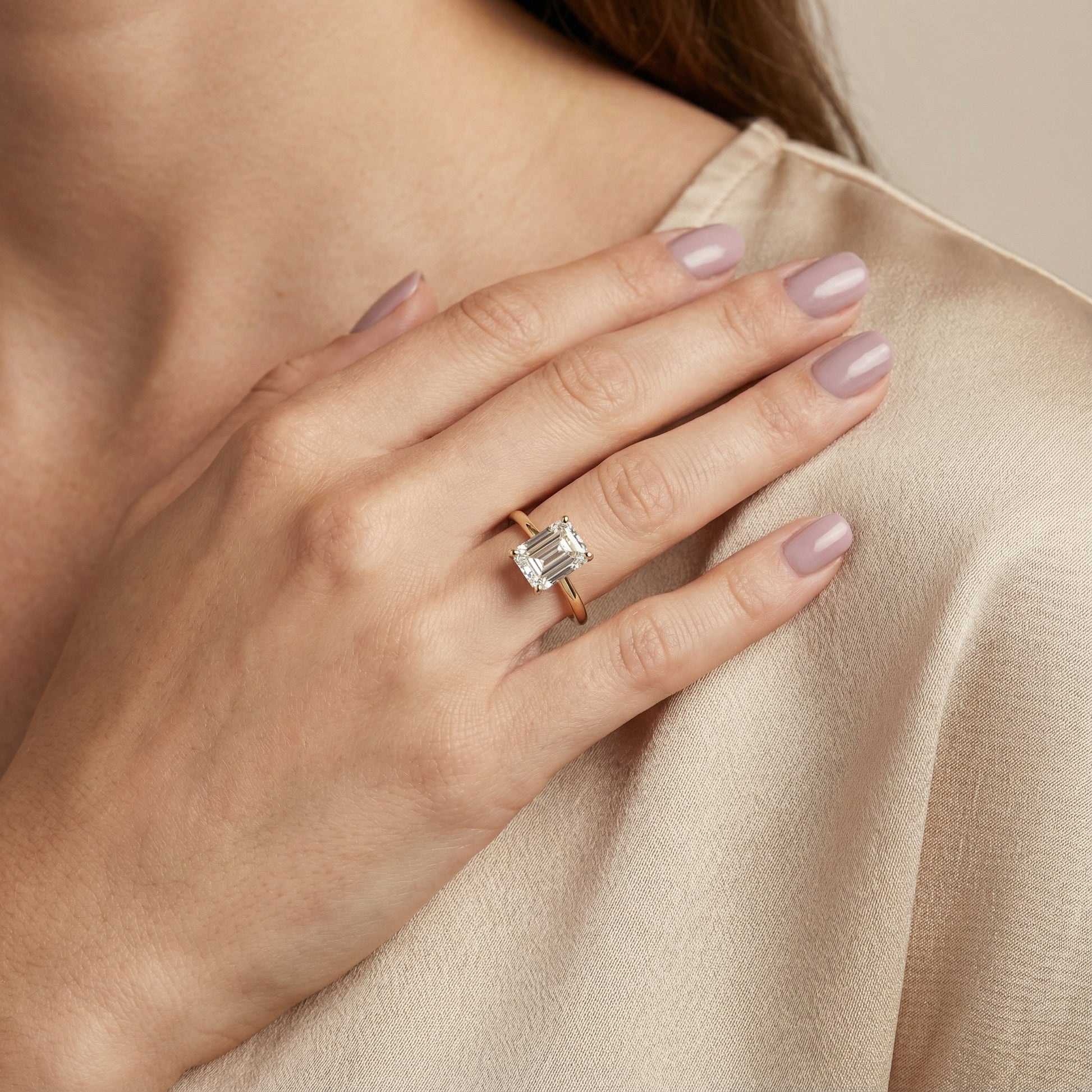 Emerald Cut Lab Grown Diamond Solitaire Engagement Ring in traditional Yellow Gold setting.