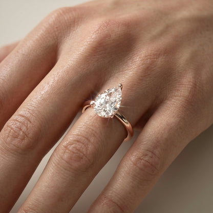 Pear Cut Lab Grown Diamond Solitaire Engagement Ring in Rose Gold with claw prongs and chevron basket.