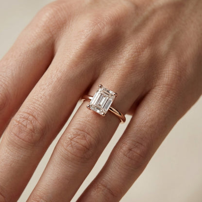 Emerald Cut Lab Grown Diamond Solitaire Engagement Ring in warm Rose Gold setting.