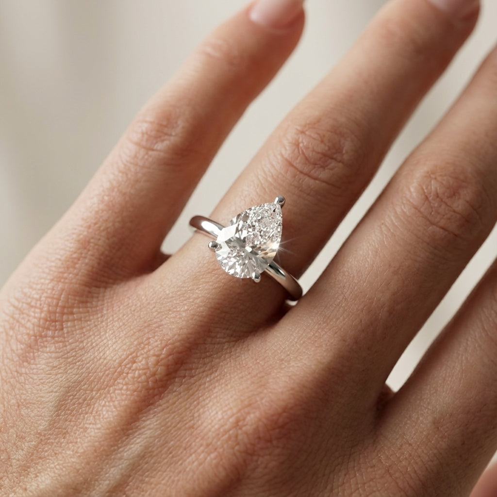 Side view of Pear Cut Lab Grown Diamond Solitaire Engagement Ring in White Gold highlighting chevron setting.