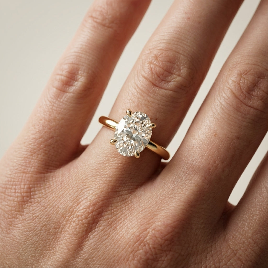 Oval Cut Lab Grown Diamond Engagement Ring in Yellow Gold with chevron under-bezel detail