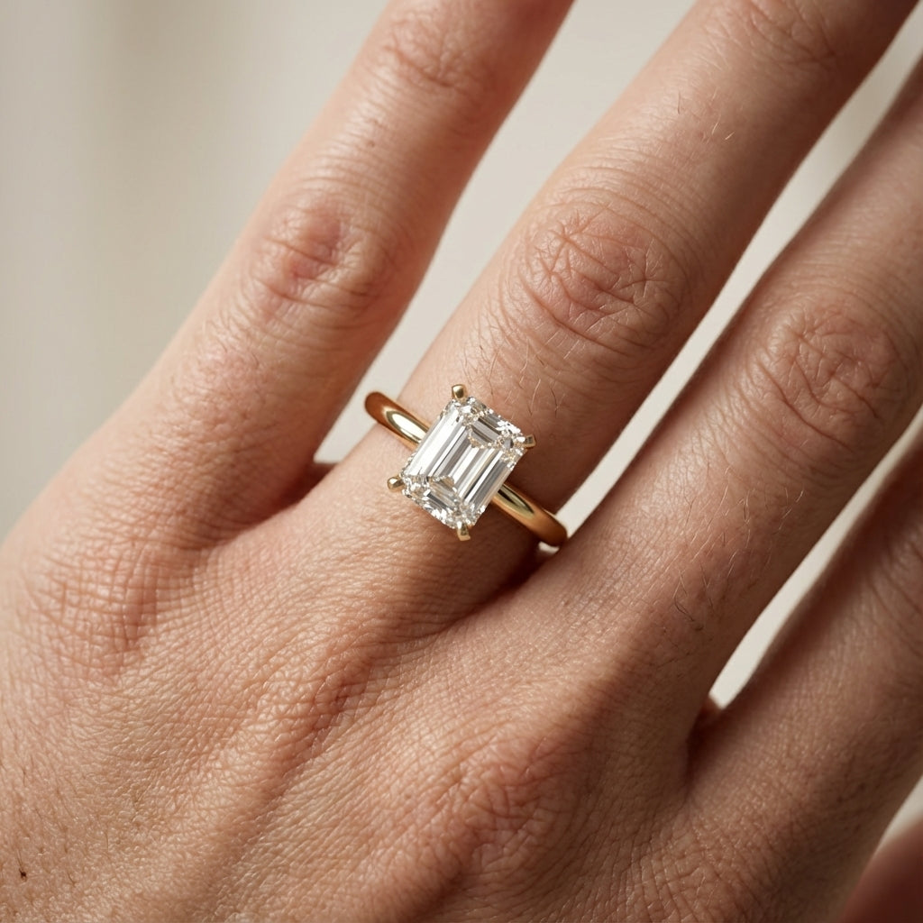Emerald Cut Lab Grown Diamond Solitaire Engagement Ring in Yellow Gold showing cathedral setting