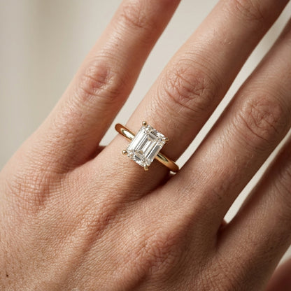 Emerald Cut Lab Grown Diamond Solitaire Engagement Ring in Yellow Gold showing cathedral setting