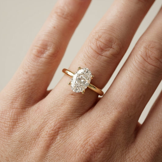 Oval Cut Lab Grown Diamond Engagement Ring in Yellow Gold with unique bridge profile