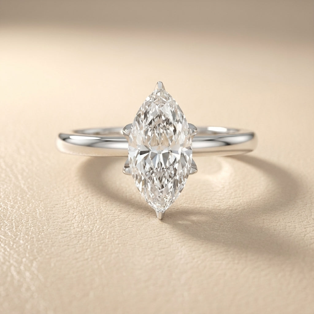 Marquise cut lab grown diamond solitaire engagement ring in silver with floral prong setting.