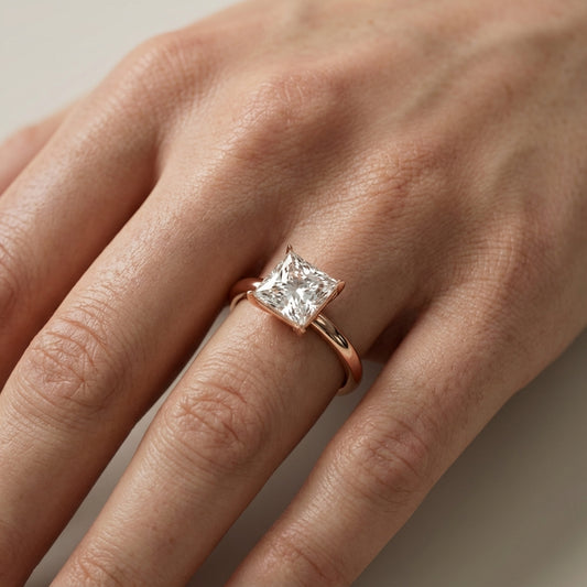 Princess Cut Lab Grown Diamond Solitaire Engagement Ring in Rose Gold showing side profile and unique setting.