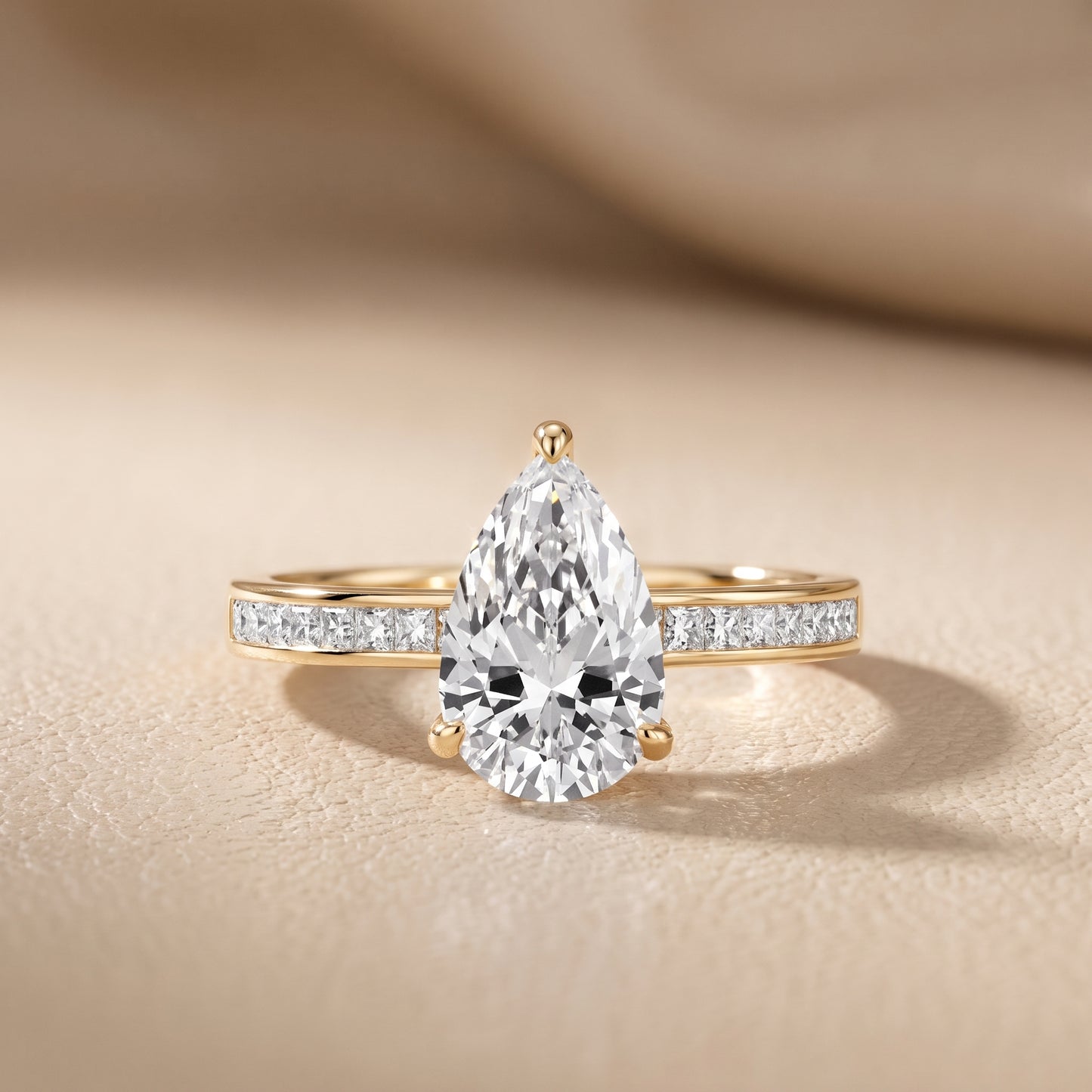 Maren Sidestone Channel Set Pear Diamond Engagement Ring in Yellow Gold - front.jpg