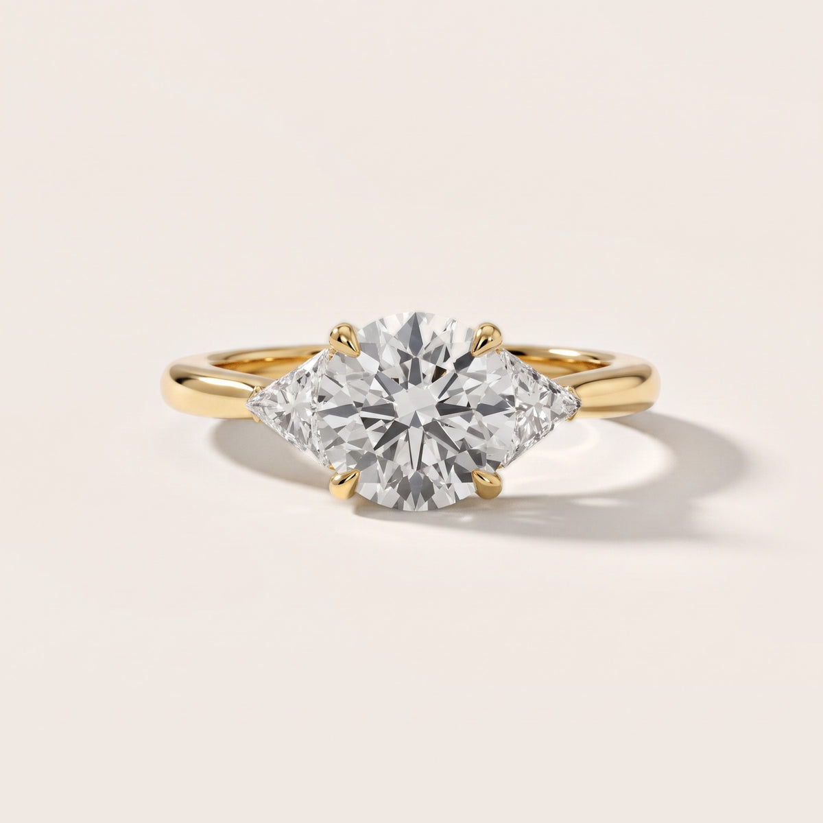 Clemency Three-Stone Cathedral Round Diamond Engagement Ring in Yellow Gold - front.jpg