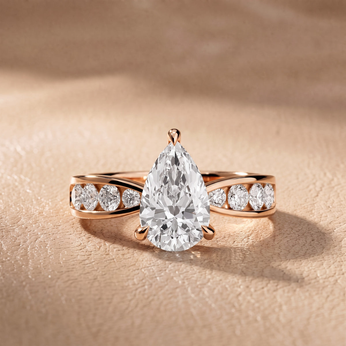Rosalie Channel Set Sidestone Pear Diamond Engagement Ring in Rose Gold - front.jpg