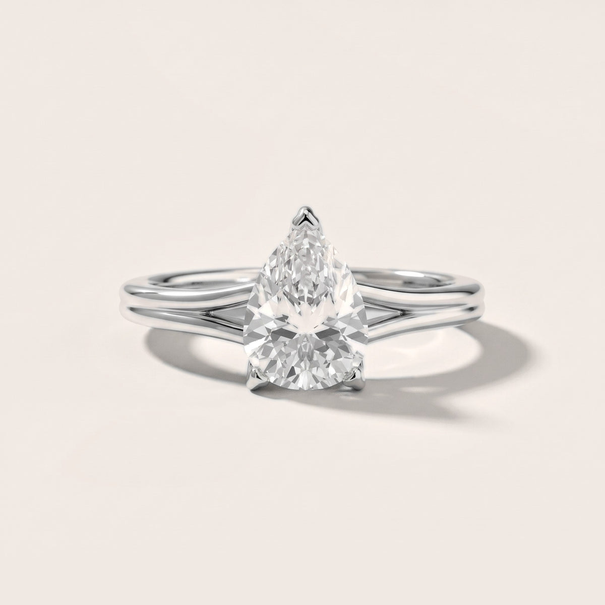 Neve Solitaire Split Shank Pear Diamond Engagement Ring in Silver - front.jpg