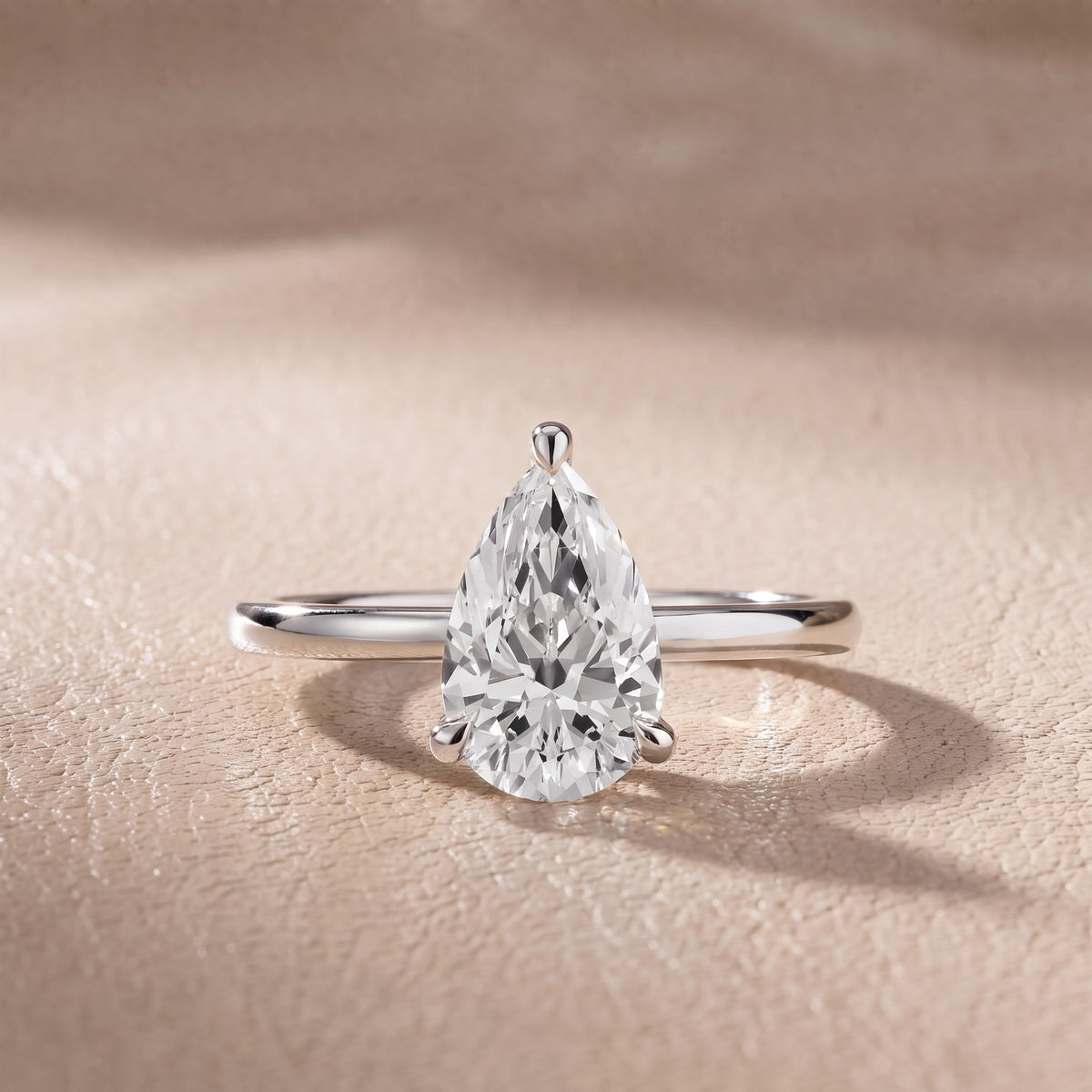 Nella Petite Solitaire Pear Diamond Engagement Ring in Platinum - front.jpg
