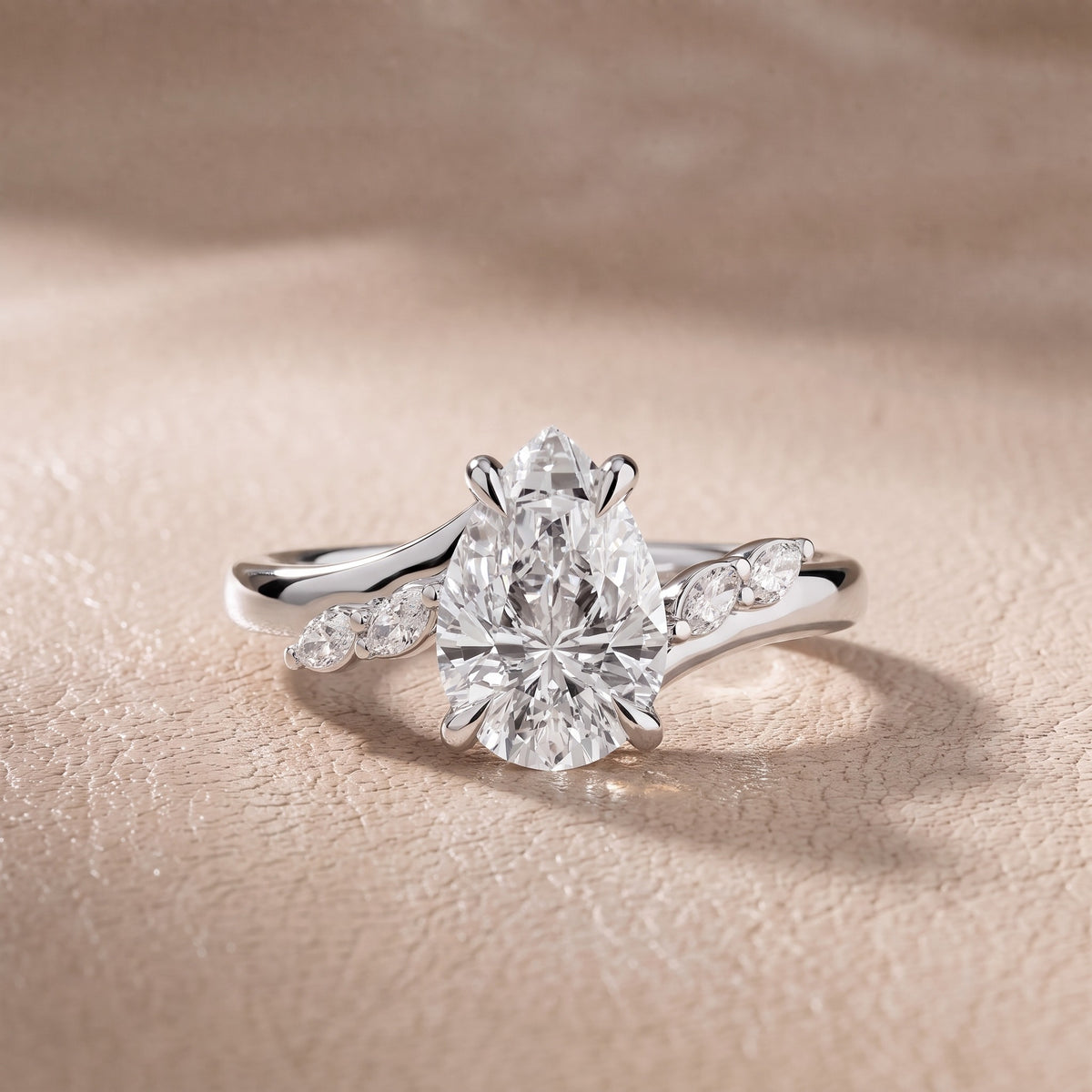 Flora Twist Side Stone Pear Diamond Engagement Ring in Platinum - front.jpg