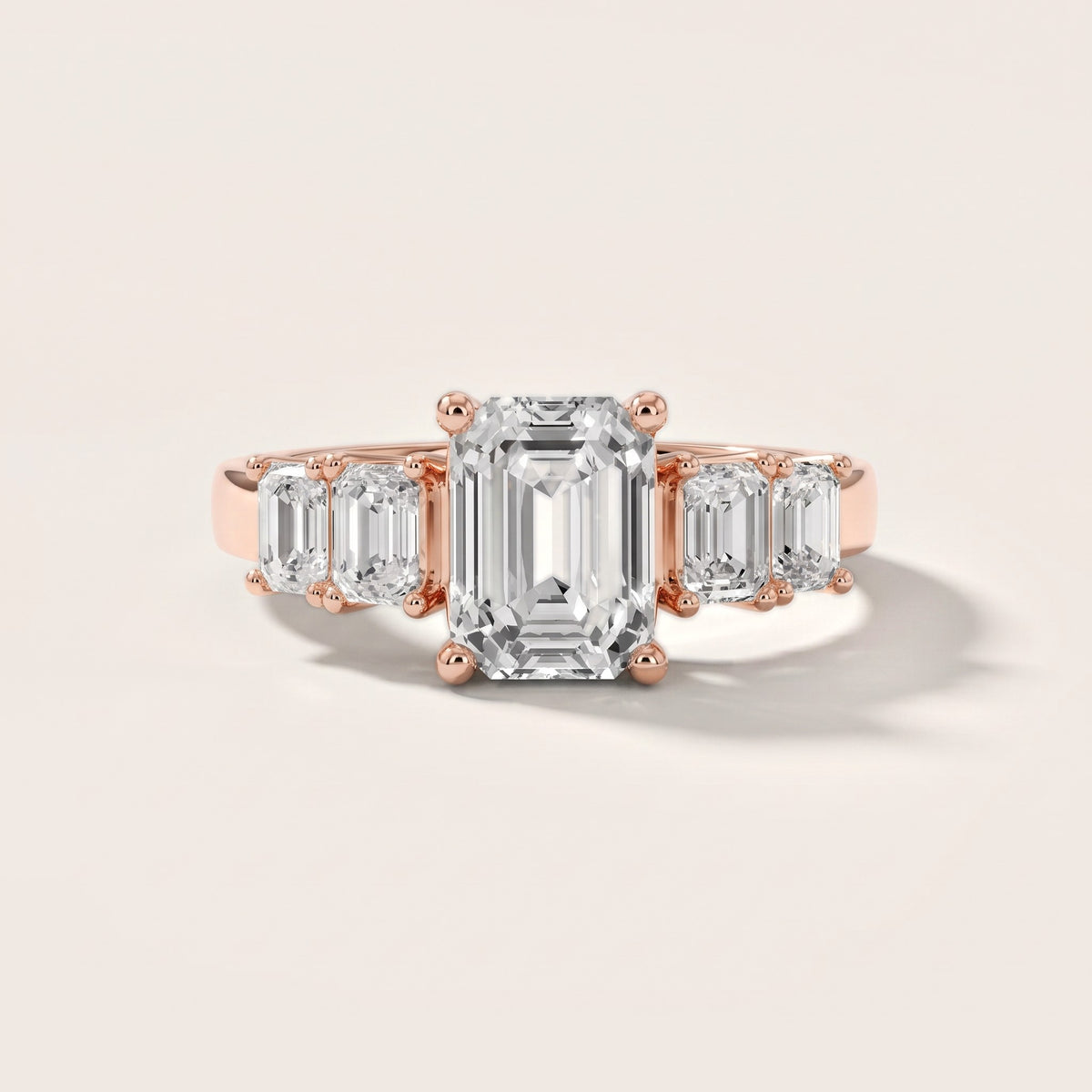 Amber Graduated Five-Stone Emerald Diamond Engagement Ring in Rose Gold - front.jpg