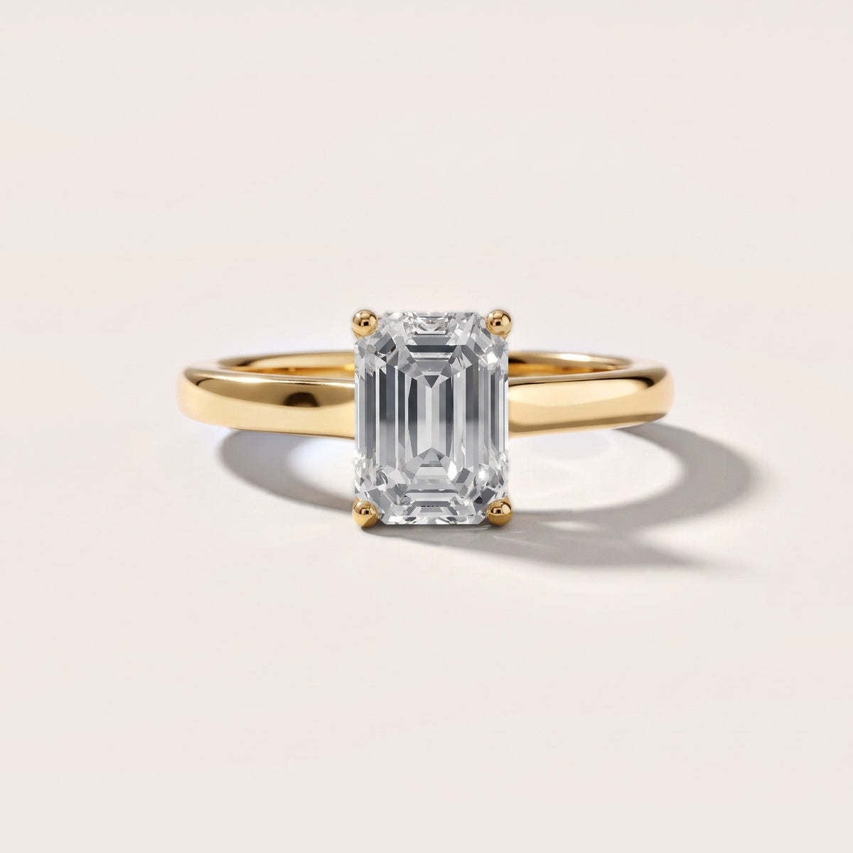 Emeline Solitaire Cathedral Emerald Diamond Engagement Ring in Yellow Gold - front.jpg