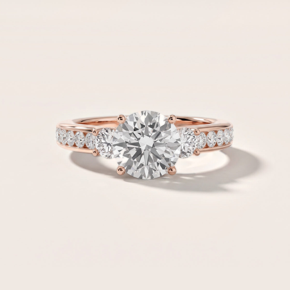 Bluebell Three-Stone Channel Set Round Diamond Engagement Ring in Rose Gold - front.jpg