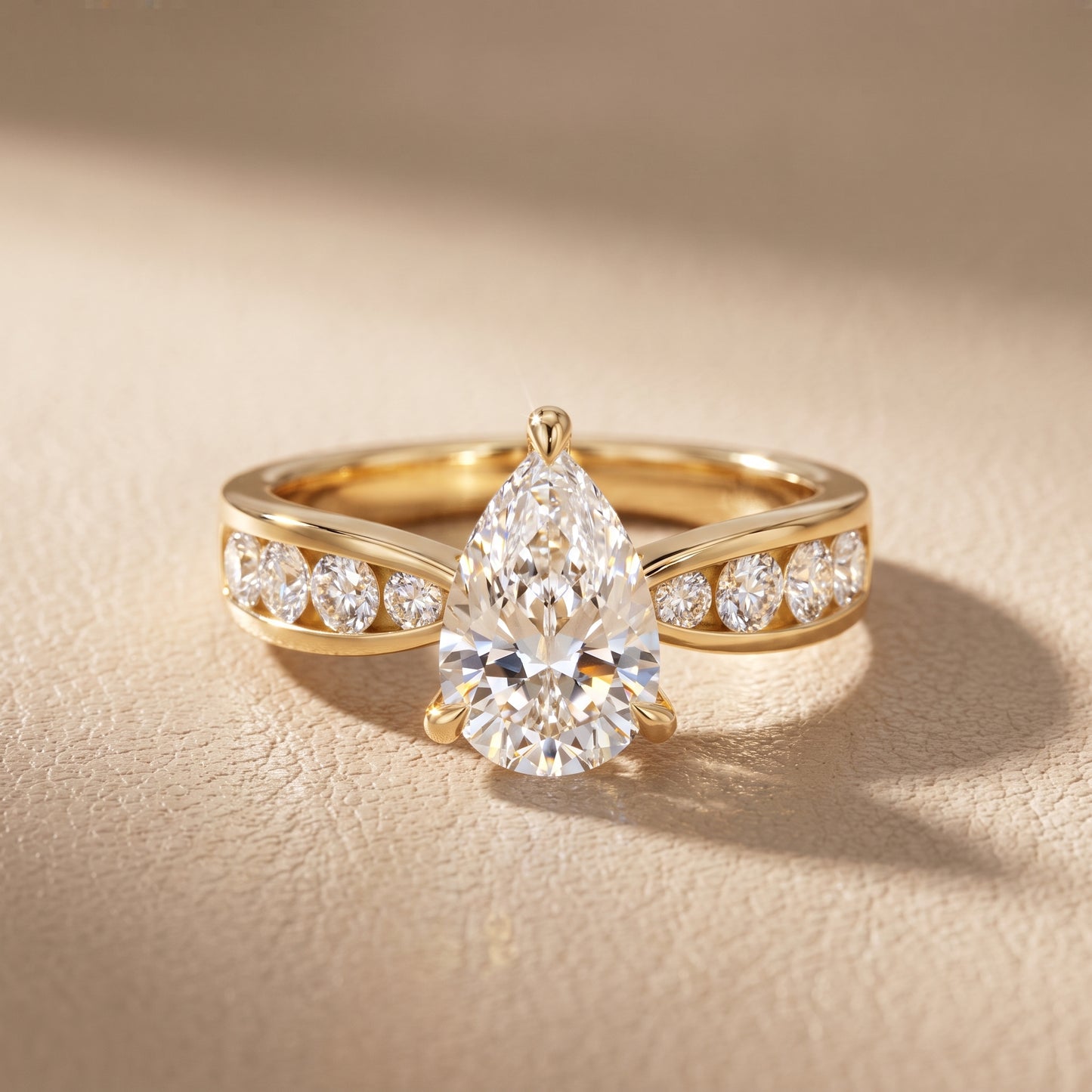 Noor Channel Set Sidestone Pear Diamond Engagement Ring in Yellow Gold - front.jpg