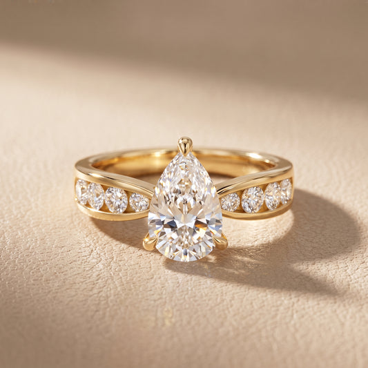 Noor Channel Set Sidestone Pear Diamond Engagement Ring in Yellow Gold - front.jpg