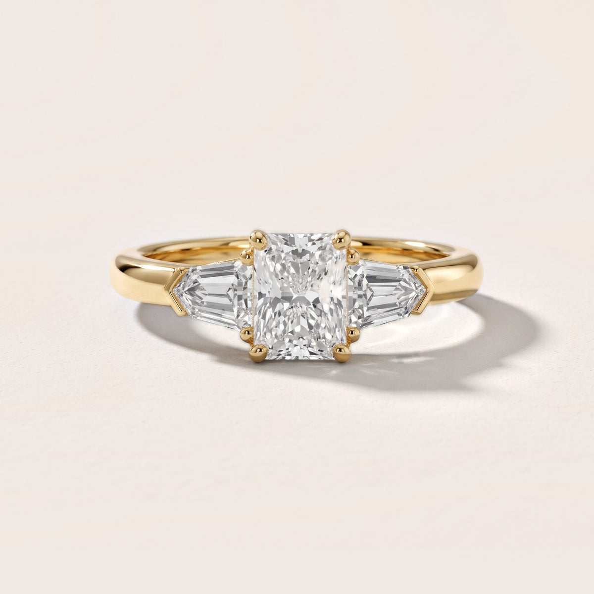 Dorothea Baguette Three-Stone Radiant Diamond Engagement Ring in Yellow Gold - front.jpg