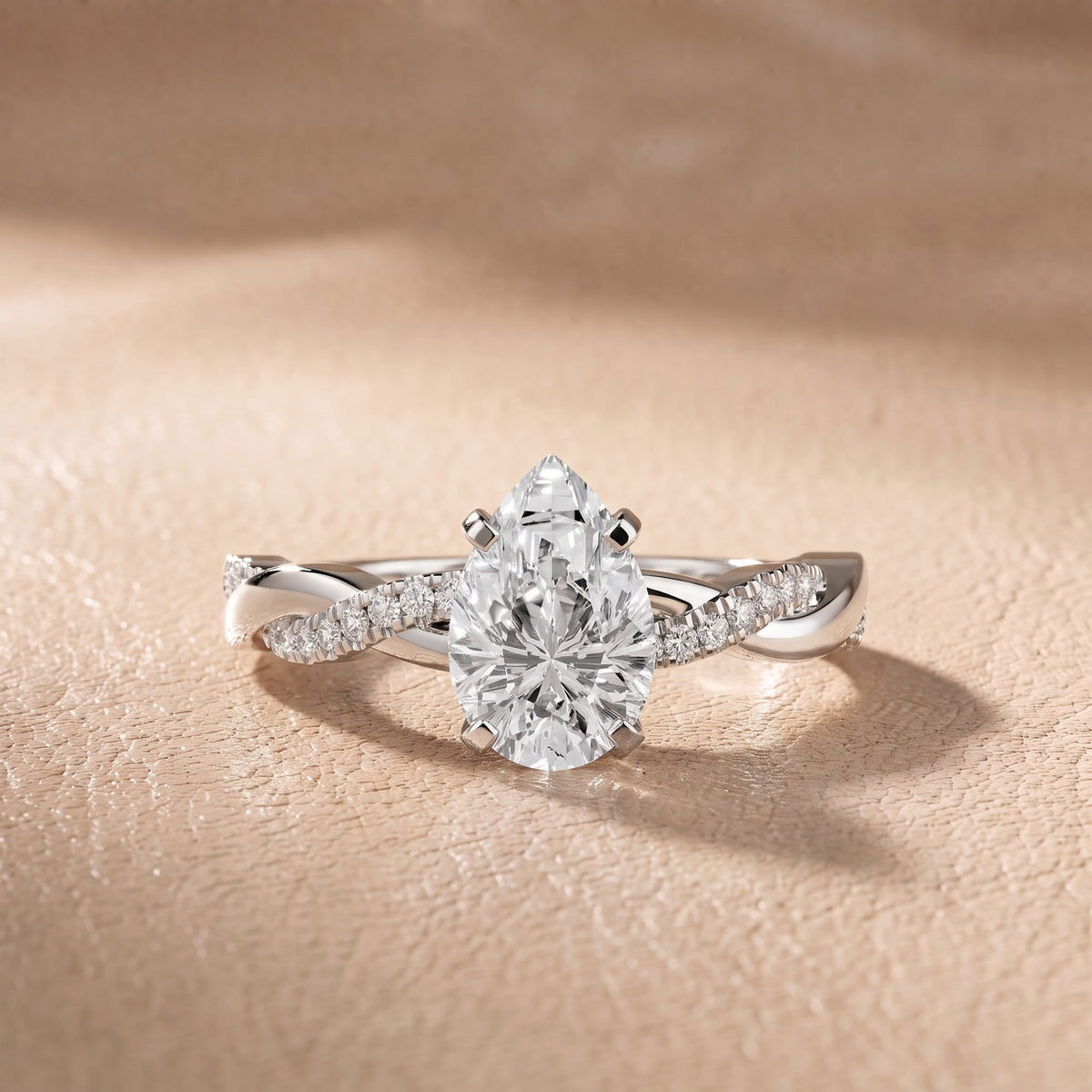 Twisted Side Stone Pear Diamond Engagement Ring in Platinum - front.jpg