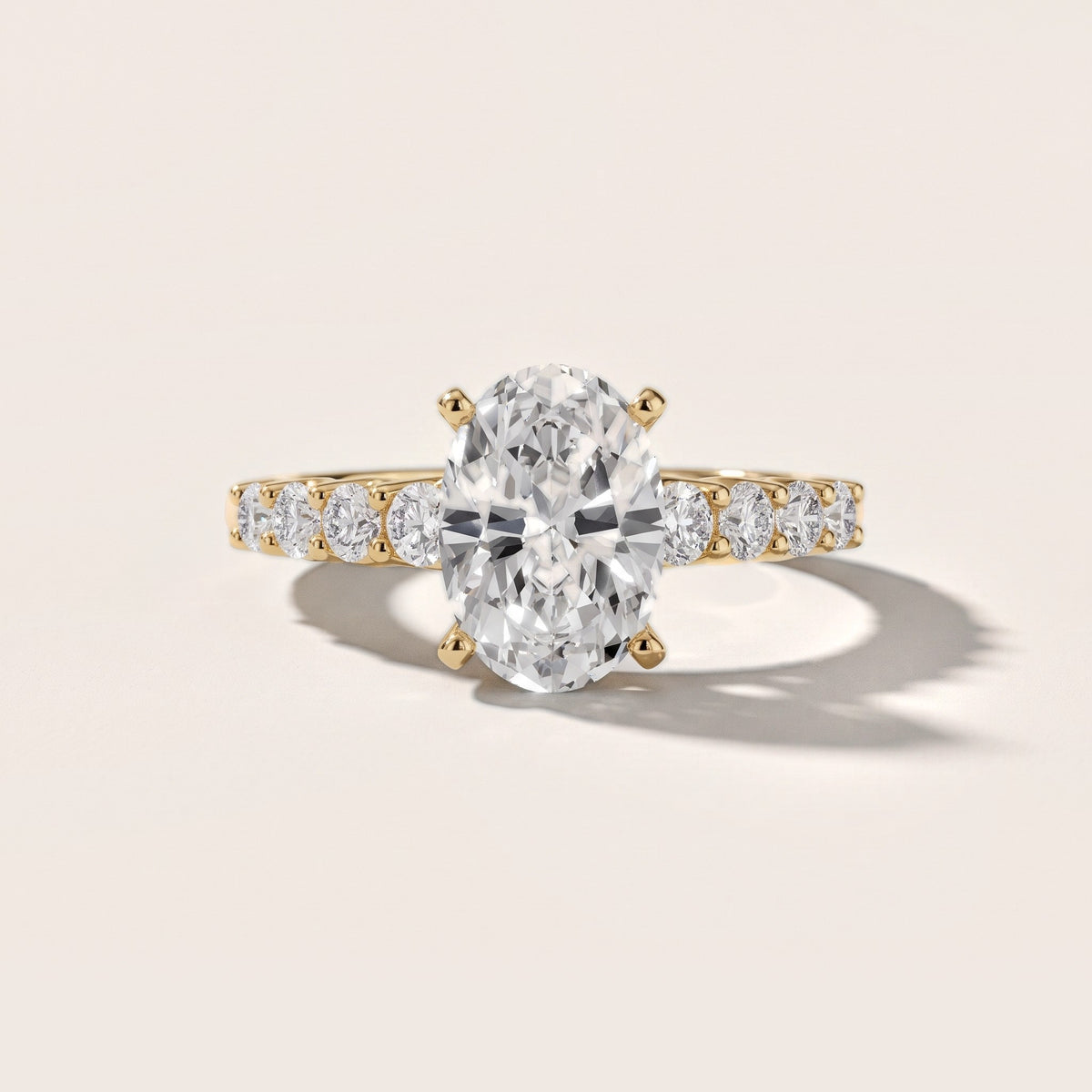 Augusta Graduated Pavé Oval Diamond Engagement Ring in Yellow Gold - front.jpg