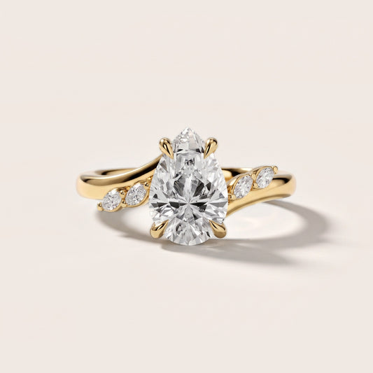 Flora Twist Side Stone Pear Diamond Engagement Ring in Yellow Gold