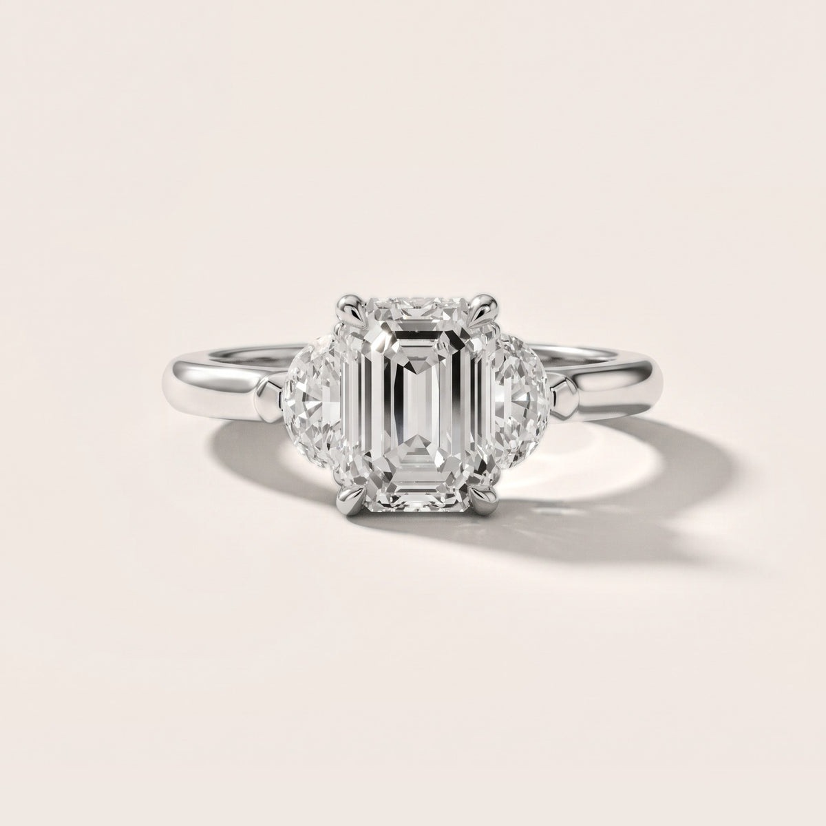 Elia Half-Moon Three-Stone Emerald Diamond Engagement Ring in Platinum - front.jpg