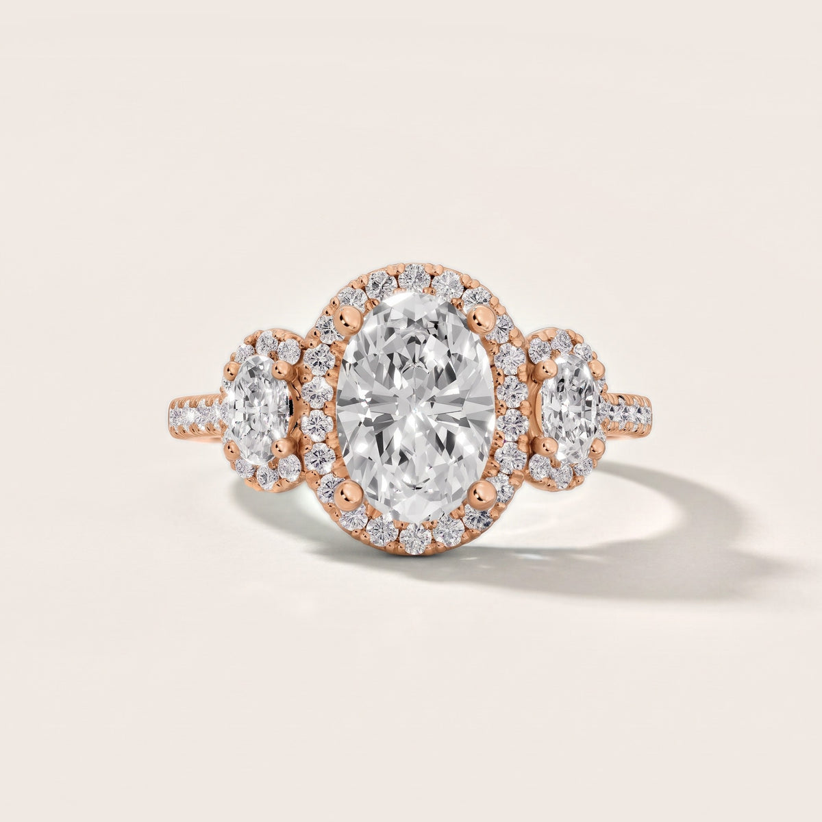 Austin Three-Stone Halo Oval Diamond Engagement Ring in Rose Gold - front.jpg