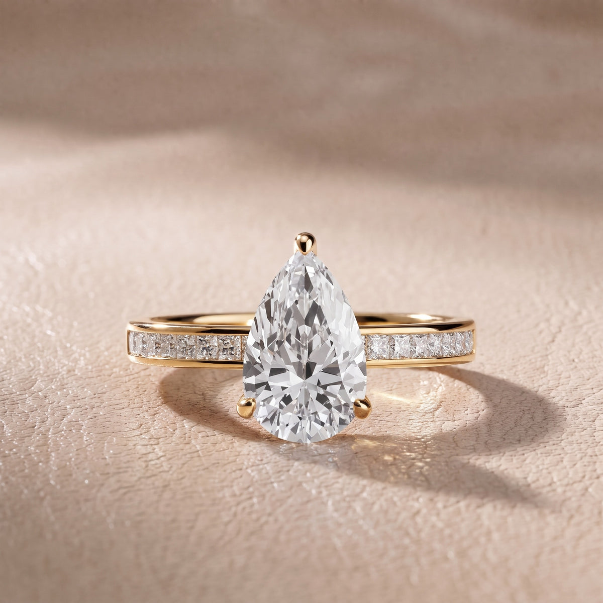 Maren Sidestone Channel Set Pear Diamond Engagement Ring in Yellow Gold - front.jpg