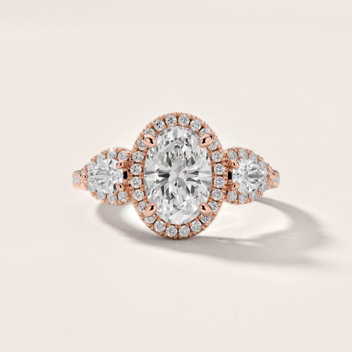 Camden Three-Stone Halo Oval Diamond Engagement Ring in Rose Gold - front.jpg