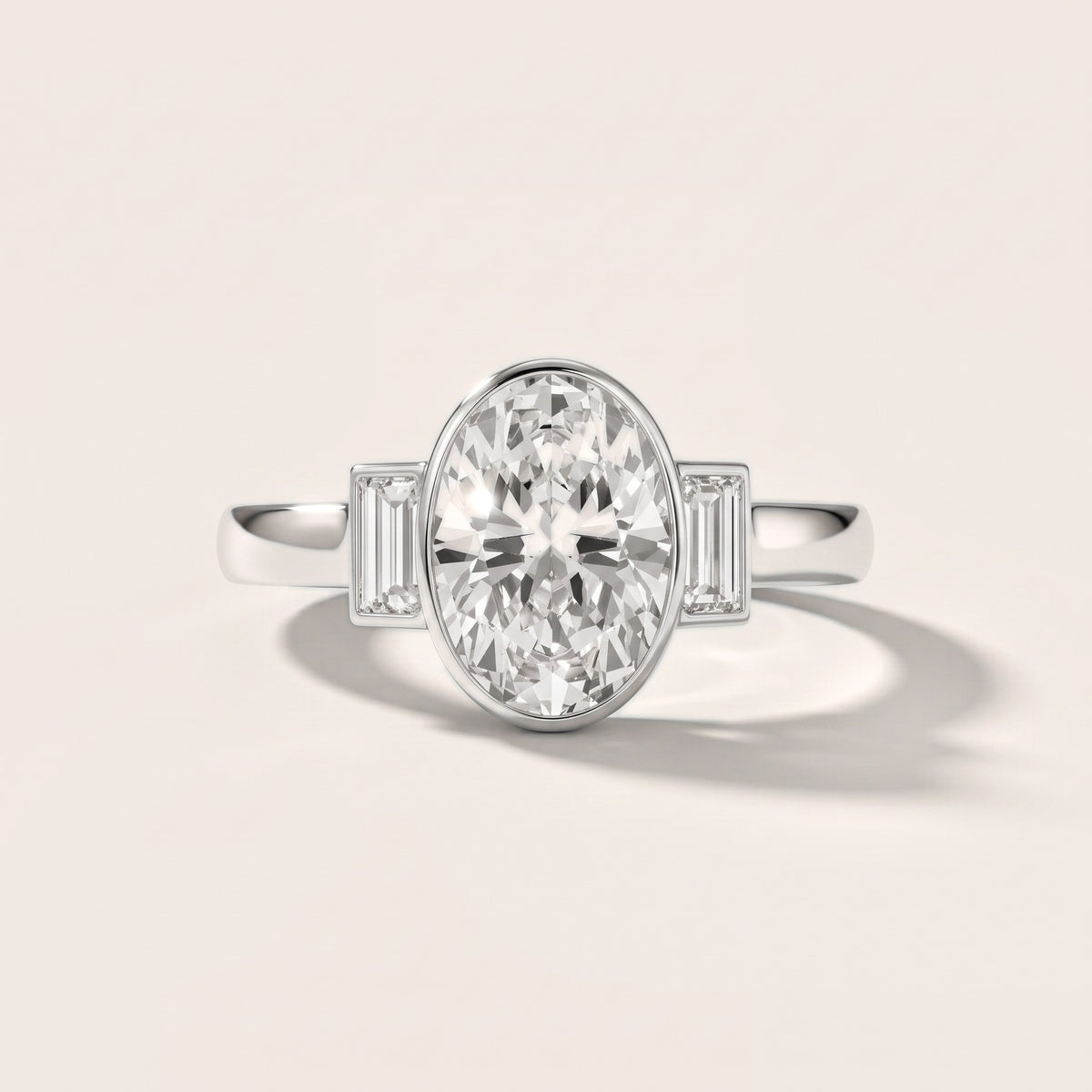 Paia Bezel Three-Stone Oval Diamond Engagement Ring in Platinum - front.jpg