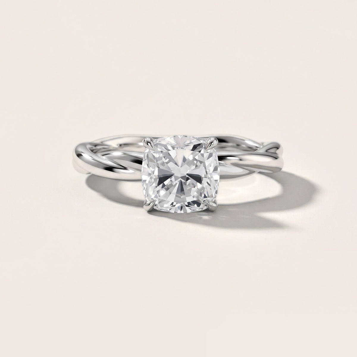 Nicola Twist Solitaire Cushion Diamond Engagement Ring in Platinum - front.jpg
