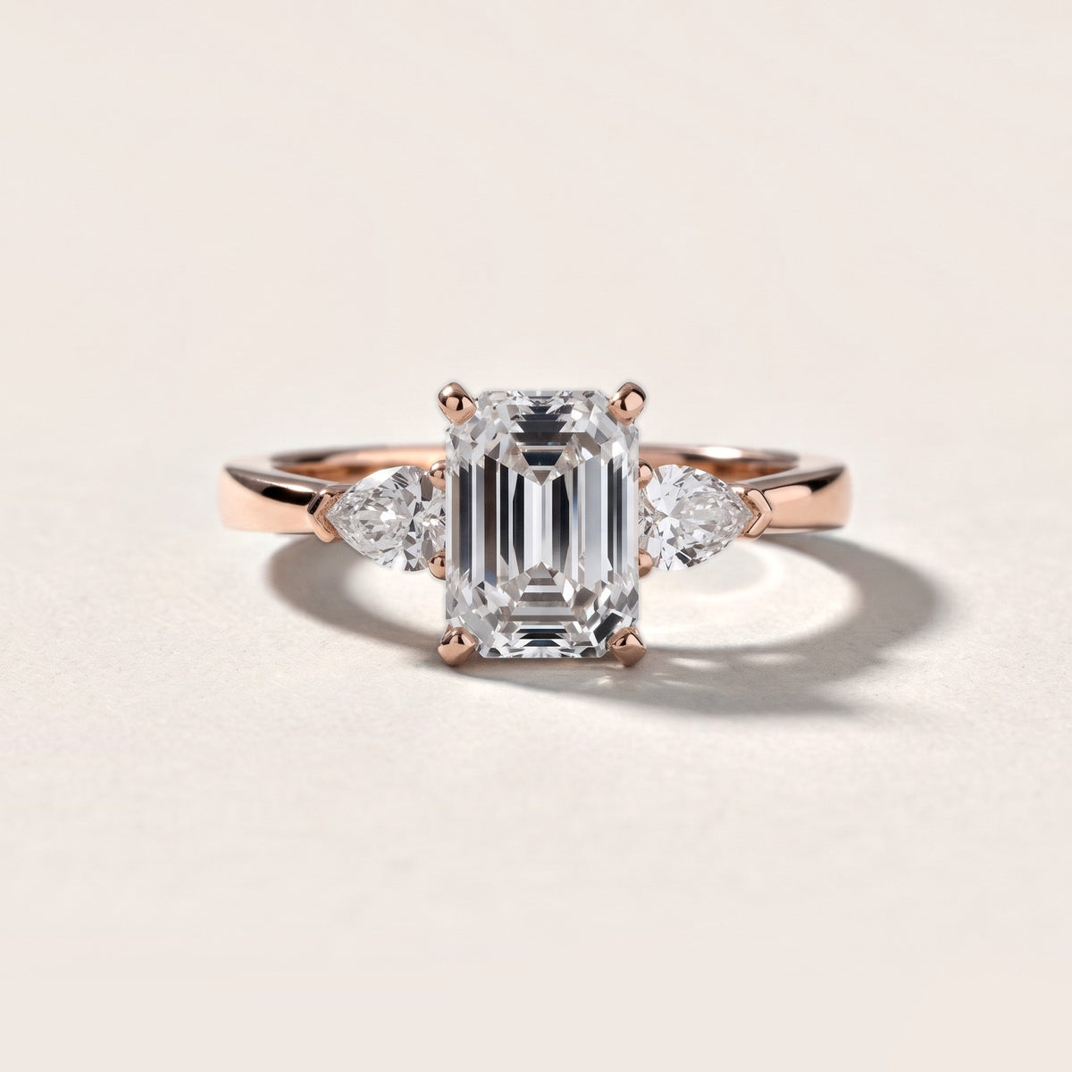 Amabel Three-Stone Emerald Diamond Engagement Ring in Rose Gold - front.jpg