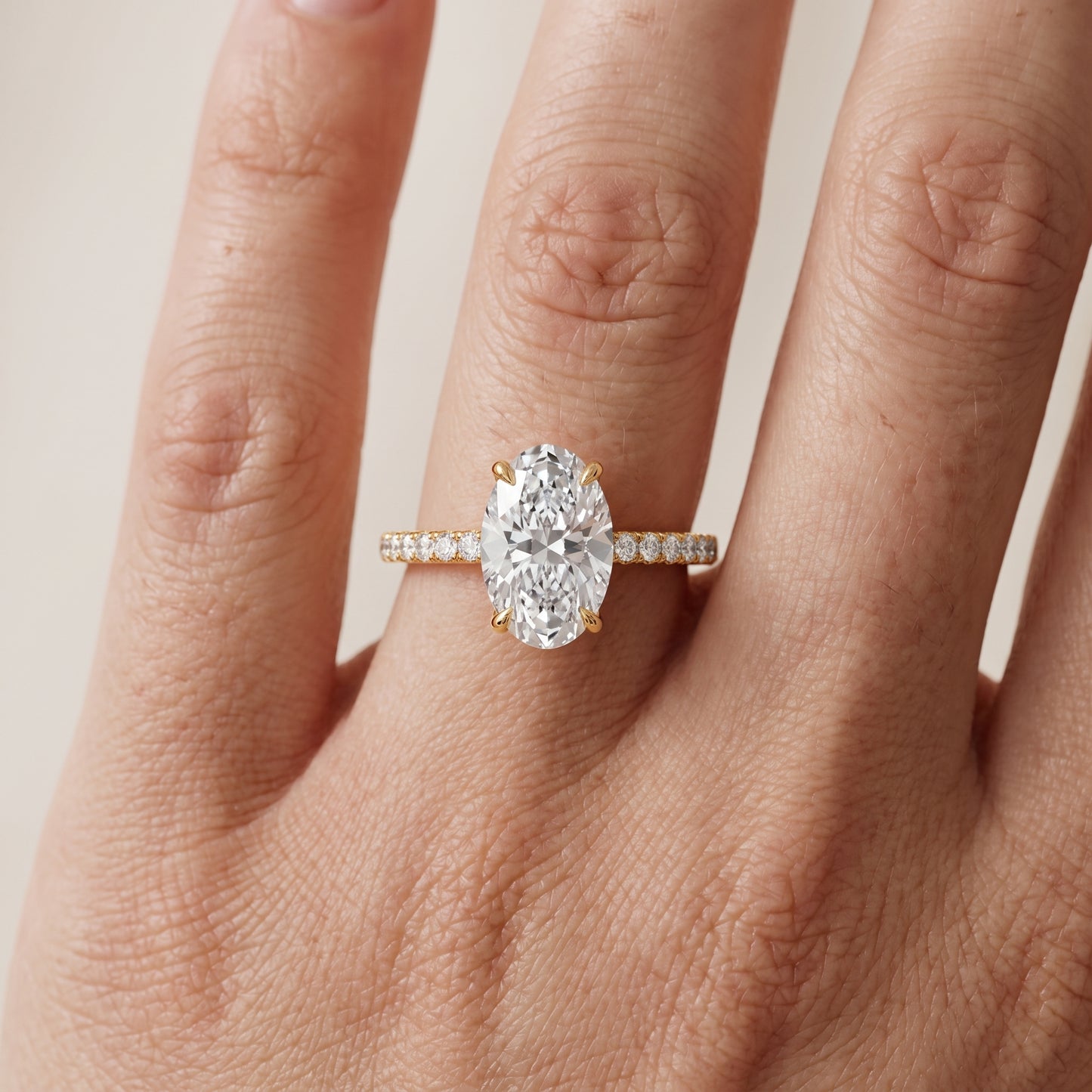 Ione Solitaire Pavé Oval Diamond Engagement Ring in Yellow Gold - lifestyle.jpg