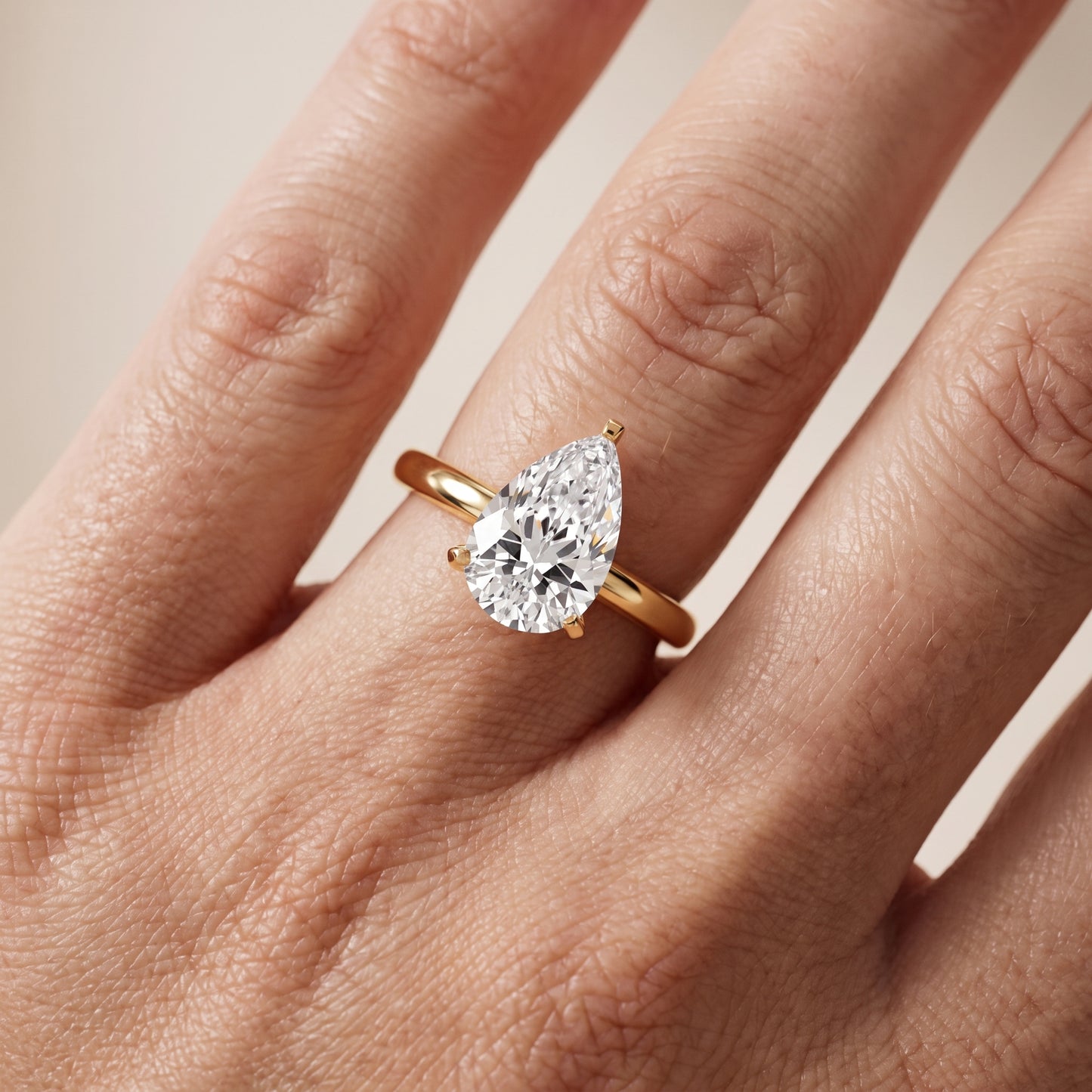 Liana Solitaire Claw Prong Pear Diamond Engagement Ring in Yellow Gold - lifestyle.jpg