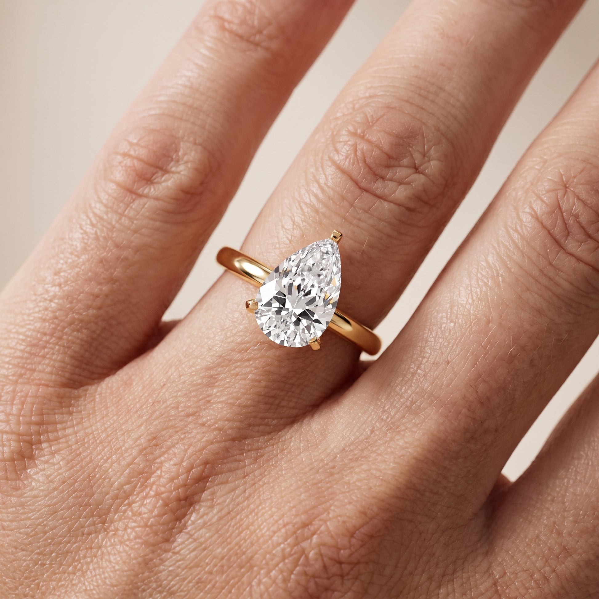 Liana Solitaire Claw Prong Pear Diamond Engagement Ring in Yellow Gold - lifestyle.jpg