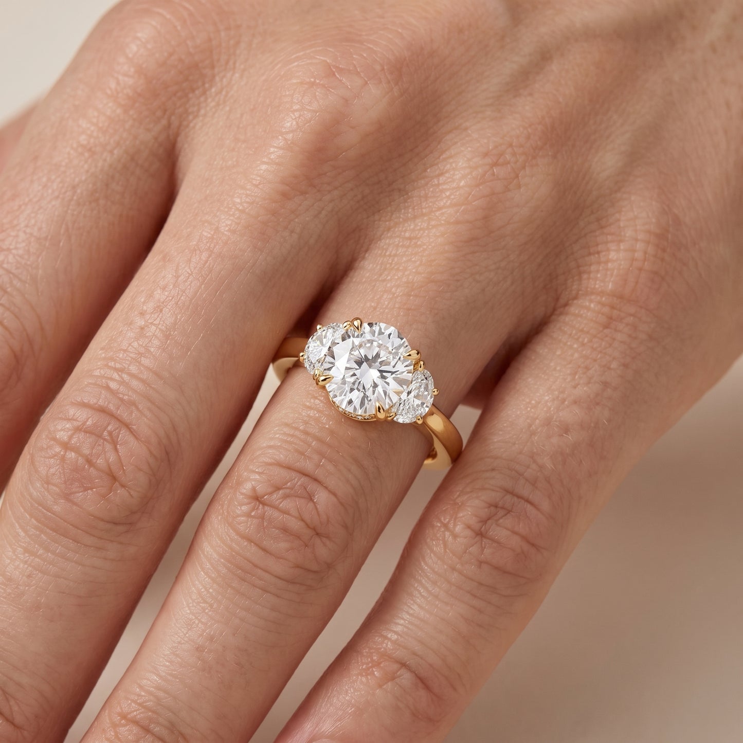Romy Three-Stone Round Diamond Engagement Ring in Yellow Gold - lifestyle.jpg