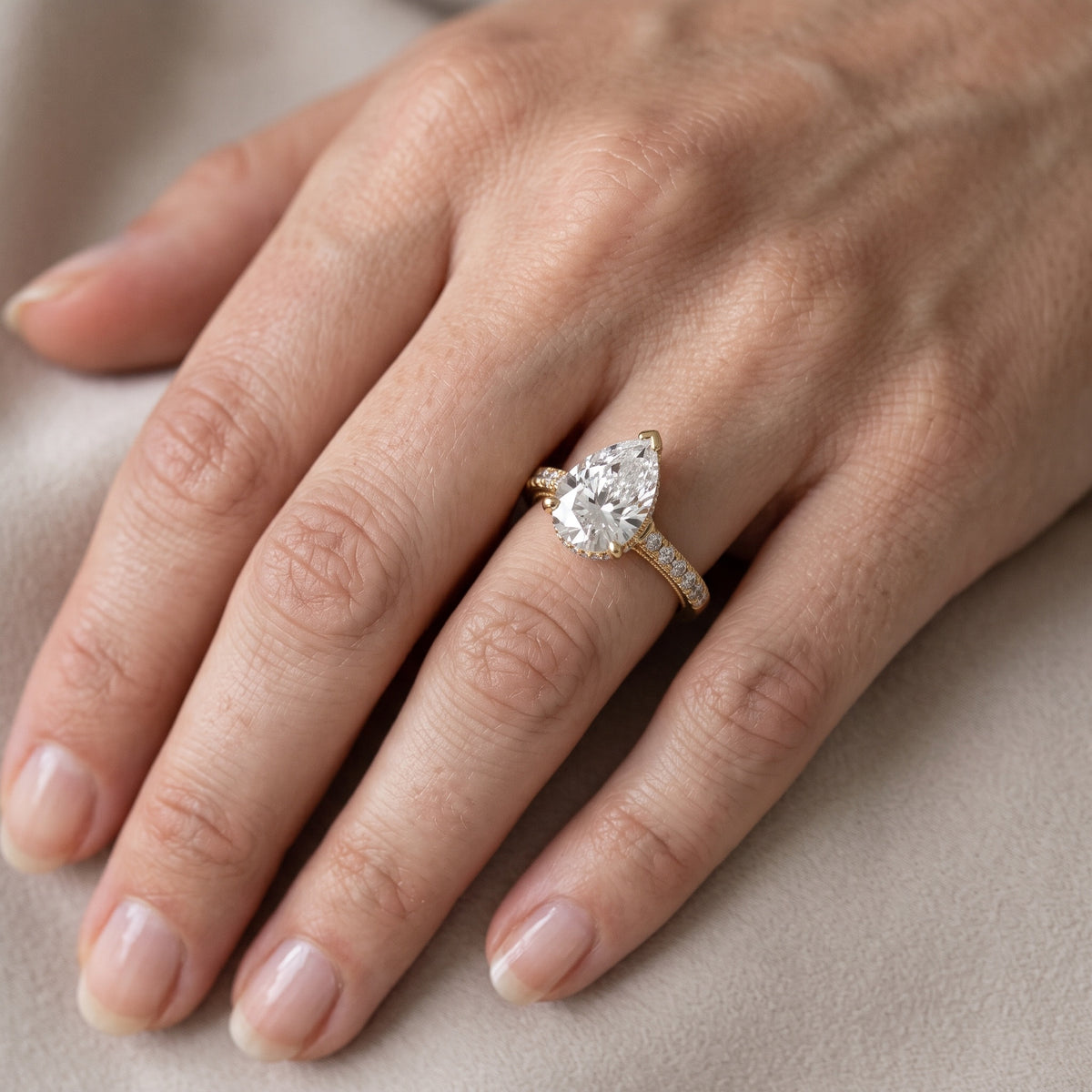 Rialto Hidden Halo Milgrain Pear Diamond Engagement Ring in Yellow Gold - lifestyle.jpg
