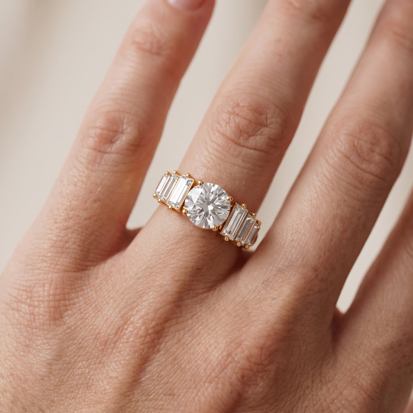 Mara Sidestone Baguette Accent Round Diamond Engagement Ring in Yellow Gold - lifestyle.jpg