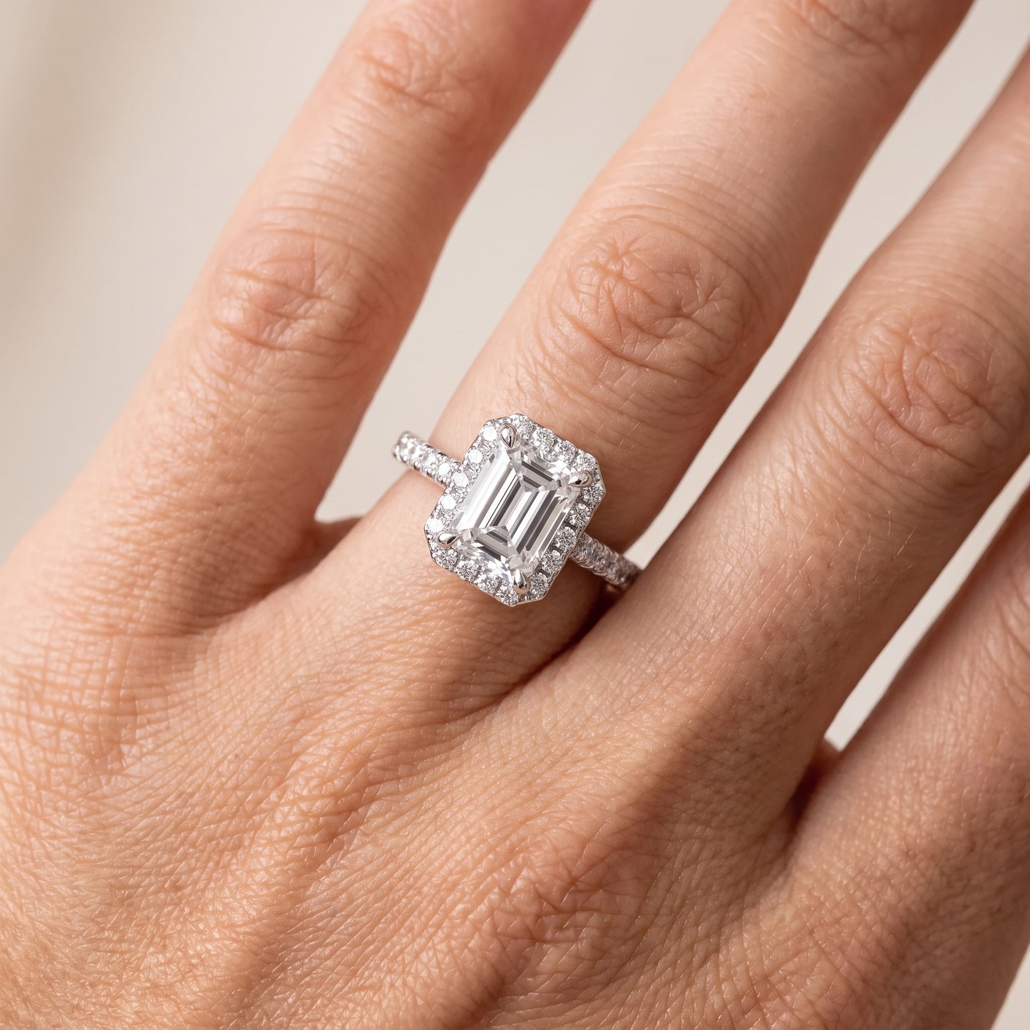 Amara Halo Claw Prong Emerald Diamond Ring in White Gold - lifestyle.jpg