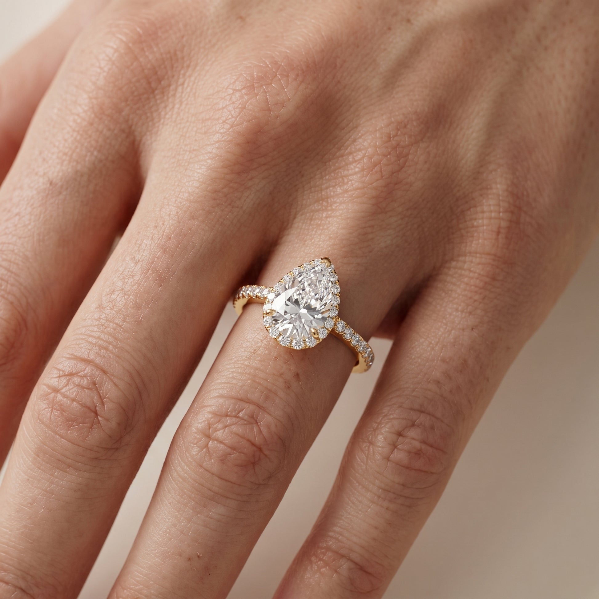 Willa Halo Micropavé Pear Diamond Engagement Ring in Yellow Gold - lifestyle.jpg