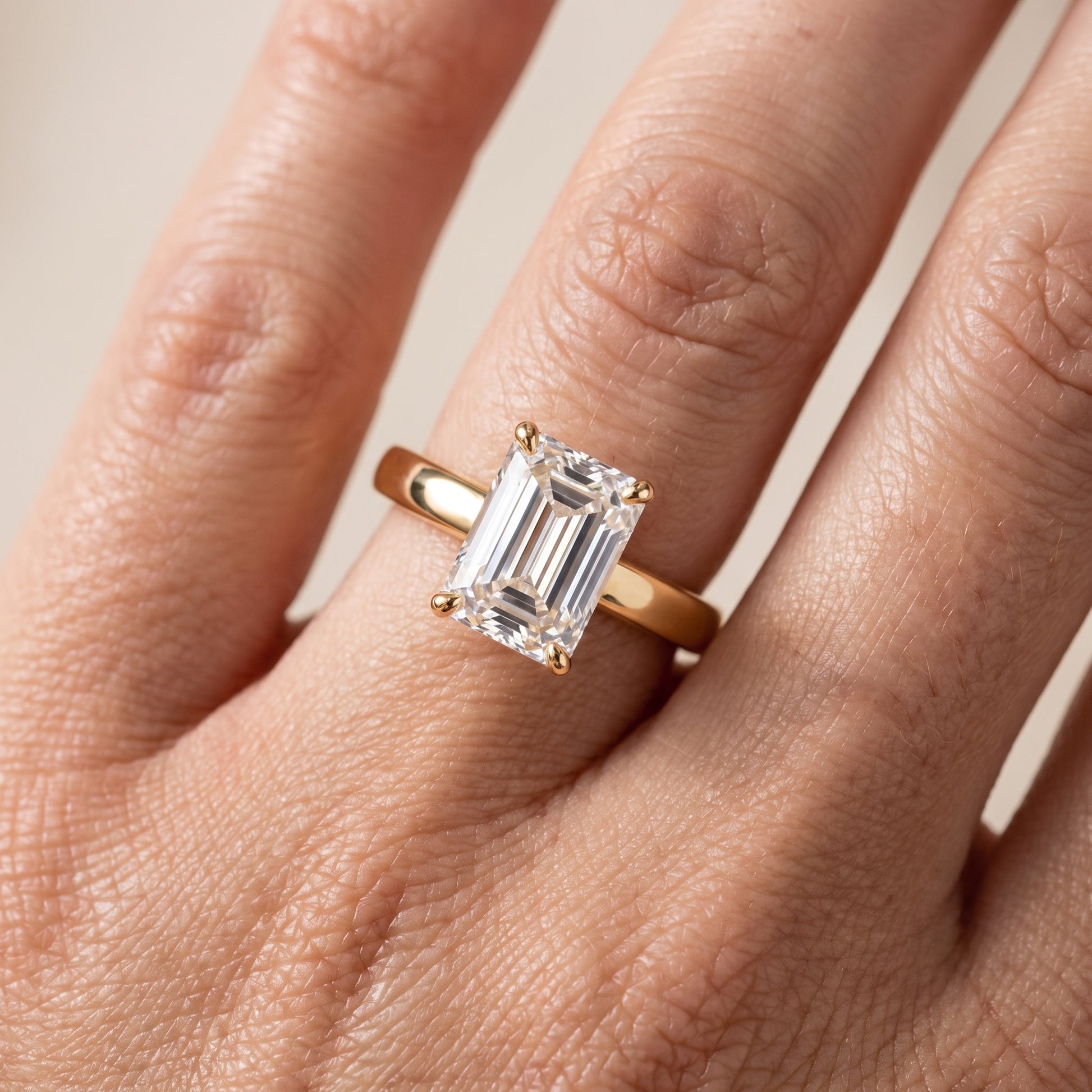 Lara Hidden Halo Emerald Diamond Engagement Ring in Yellow Gold - lifestyle.jpg