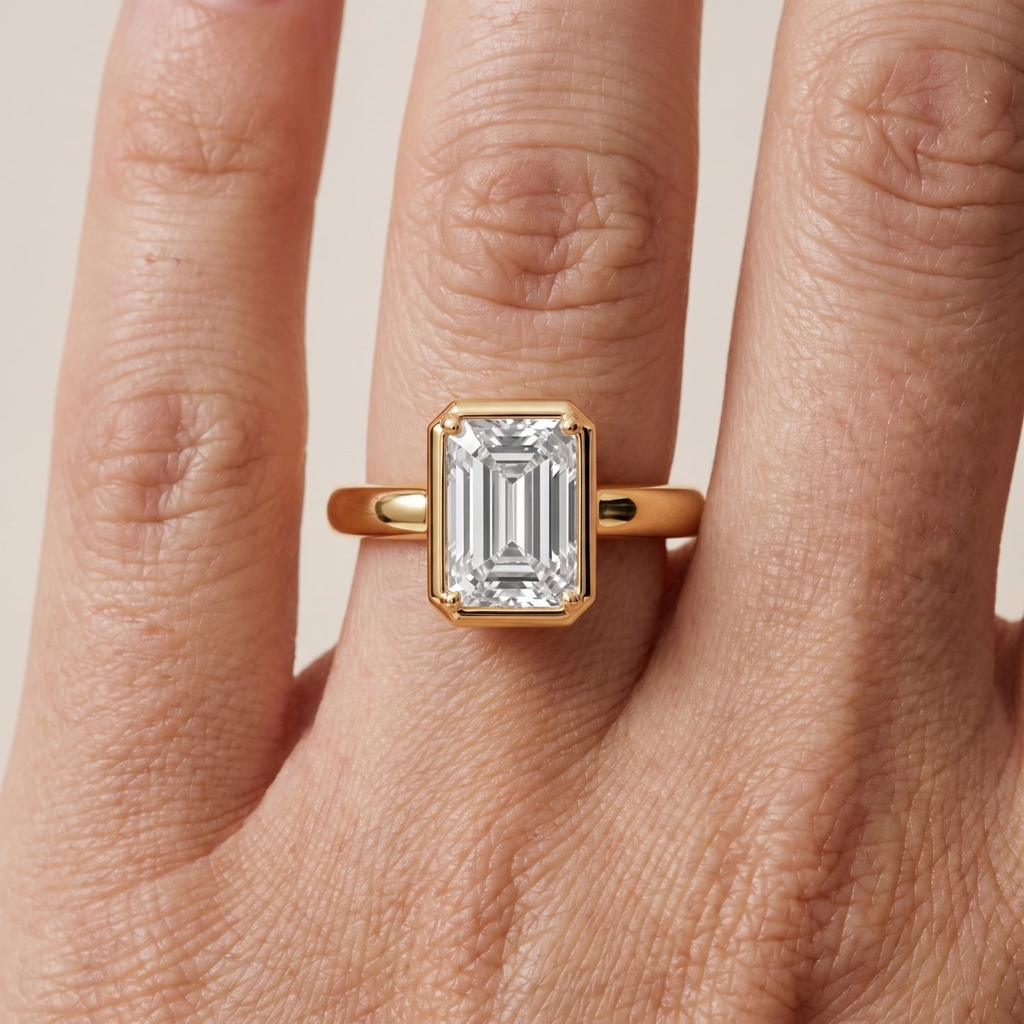 Alina Bezel Solitaire Emerald Diamond Ring in Yellow Gold - lifestyle.jpg