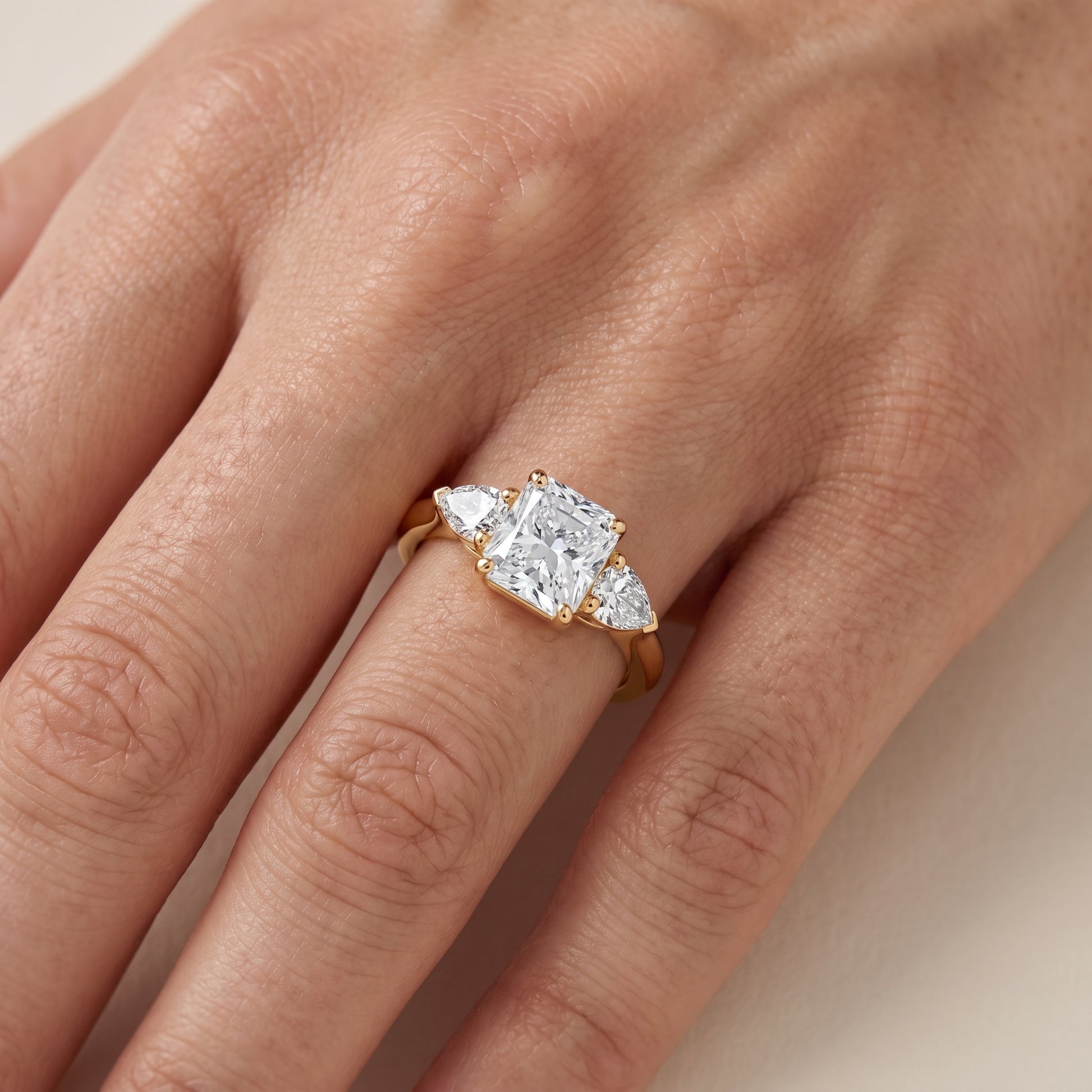 Mirabel Three-Stone Radiant Diamond Engagement Ring in Yellow Gold - lifestyle.jpg
